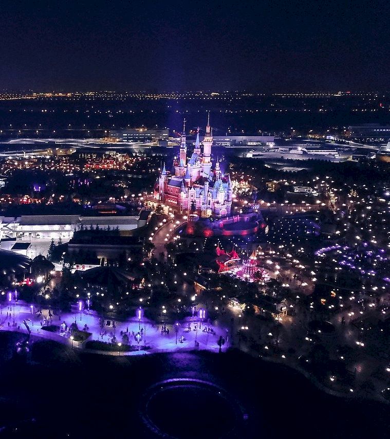 aerial view of a city at night with a large castle